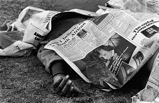 Peter Magubane, Dead bodies covered by newspaper filled the streets of Soweto during the 1976 riots, June 1976. Courtesy the artist.